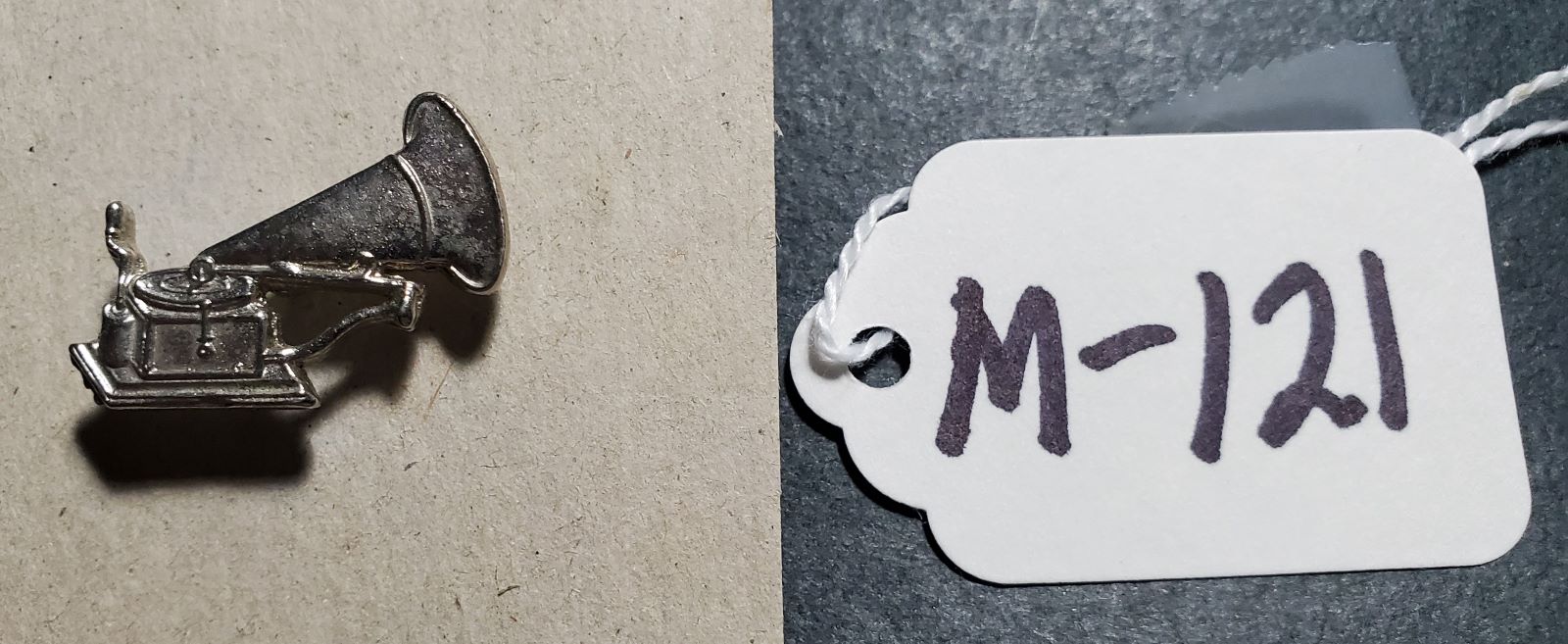 M-121  Lapel or Tie PIN showing a front-mount phonograph.